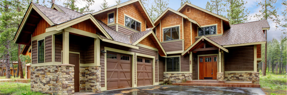 Large Home with garage and log cabin appearance.
